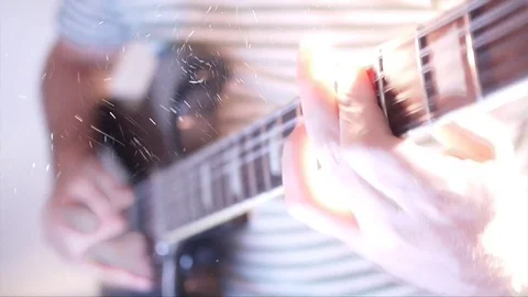 Close up of Blurred Guitar Player Strumming And Particles Floating Stock Footage 79690730