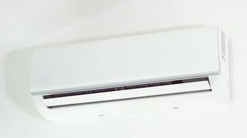 Close up of blurred hand turns off the white air conditioner on the wall with Stock Footage 260722281