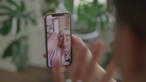 Close up of Blurred Person Holding Cell Phone Waving during FaceTime at Home Stock Footage 222005276