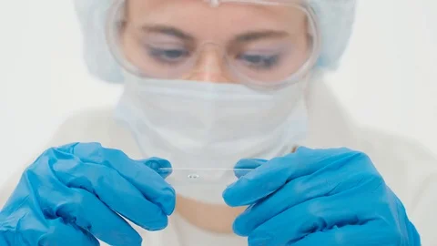 Close-up of a blurred young employee of a large research laborat Stock Footage 128233507