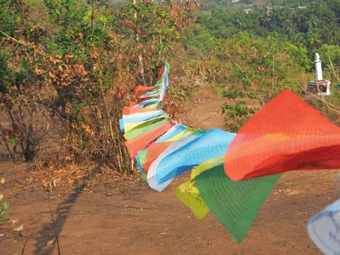 Close up blurry multicolored Buddhist flags with mantras flutter in the wind Stock Photos