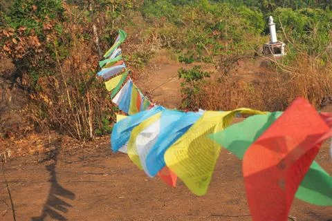 Close up blurry multicolored Buddhist flags with mantras flutter in the wind Stock Photos