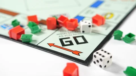 Close up of a board game with dice rolled across into red and green house Stock Footage 89186617