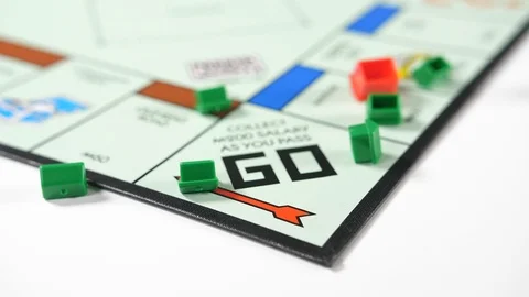 Close up of a board game with dice rolled into red and green house shaped Stock Footage 89186632