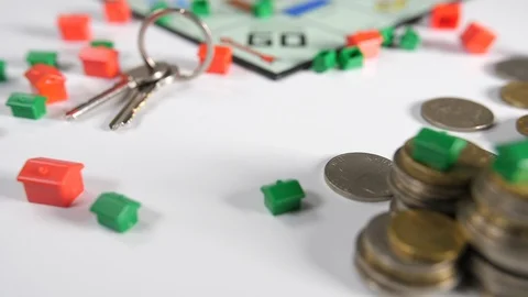 Close up of a board game of a rolling set of keys, red and green house shaped Stock Footage 89186319