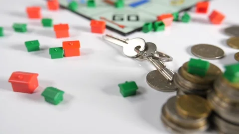 Close up of a board game of a set of keys, red and green house shaped playing Stock Footage 89186344