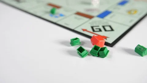Close up of a board game of with a spinning dice and moving red and green shape Stock Footage 89186401