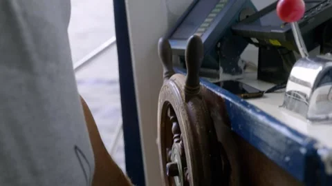 Close-Up of Boat Captain's Hands Steering a Wooden Wheel Stock Footage 304037818