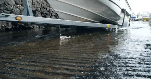 Close up of boat pulled out of water on trailer at launch ramp Stock Footage