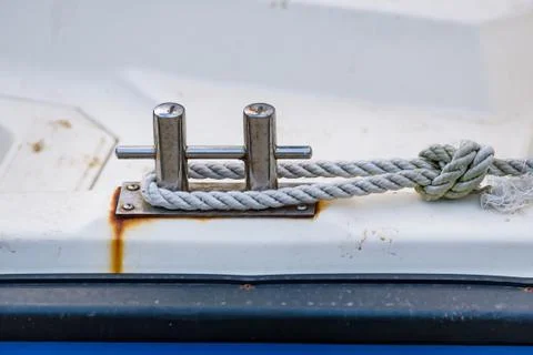 Close up of boat rope tied to nautical cleat hitch on boat Stock Photos