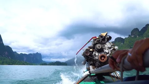 Close up of a boatman's hands driving the longtail boat with a big motor engine. Stock Footage 82679233