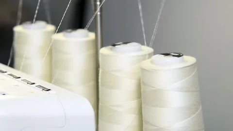 Close-up of a bobbin with threads and parts of a sewing machine, in the pro.. Stock Footage 328228668