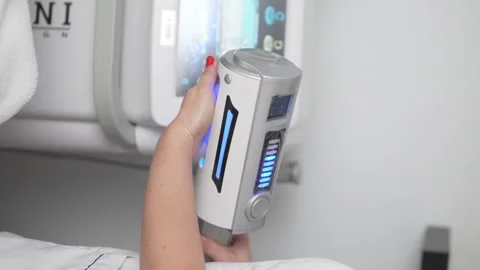 Close-up of a body massage machine in the hands of a female masseuse Stock Footage 295028210