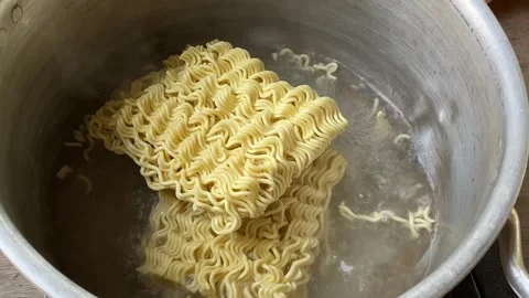 Close up of Boil instant noodles in boiling water in a country kitchen Stock Footage 287825068