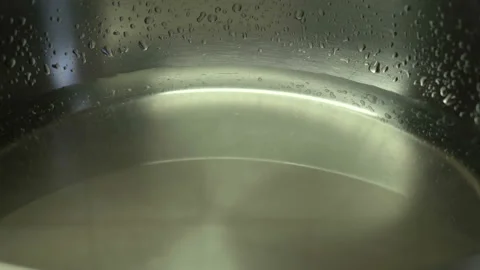 Close-up, Boil water bubble in coating pan heating Stock Footage 127522950