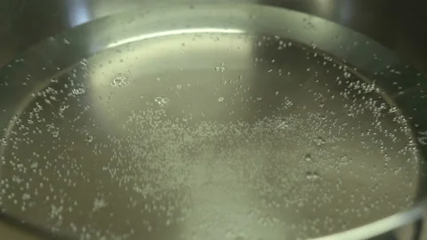 Close-up, Boil water bubble in coating pan heating Stock Footage 127523444