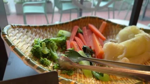 Close-up of boiled carrots, broccoli, and cauliflower in a basket Stock-Footage 312094461