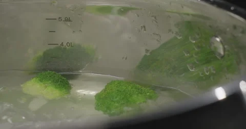 Close-up of boiling broccoli with steam in slow motion. Cooking broccoli on dark Stock Footage 252723880