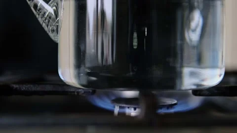 Close-up of a boiling glass kettle, highlighting the captivating bubble patterns Stock Footage 306048519