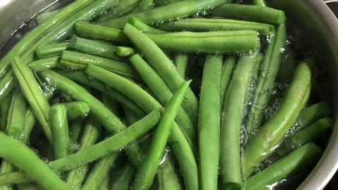 Close up of boiling green string beans in hot water in metal pot. Stock Footage