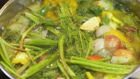 Close up of boiling green vegetables in a stainless steel stock pot on an Stock Footage 263197130