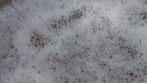 Close up of Boiling Liquid with Bubbles and Foam on Surface in Kitchen Pot Stock Footage 339658898