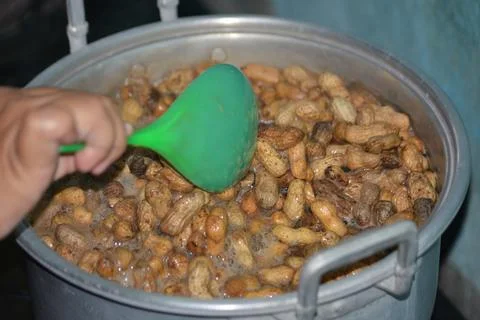 Close up of boiling peanuts in large cooking pot 写真素材