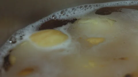 Close up of Boiling Potatoes in a Pot with Bubbling Water for Cooking Meal Stock Footage 339630274