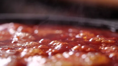 Close-up of boiling red tomato sauce in slow motion for making pizza or pasta Stock Footage 140664570