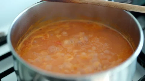 Close-up of boiling tomato sauce in stainless pan, homemade vegetable sauce Stock Footage 145684426