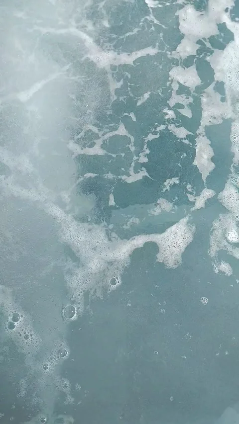 Close up of boiling turquoise water surface with white sea foam and bubbles Stock Footage 344453433