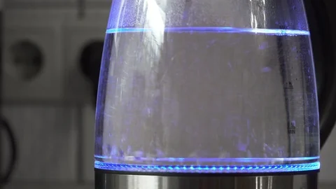 Close up of boiling water with bubbles in transparent electric kettle made of gl Stock Footage 84278021
