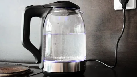 Close-up of boiling water in an electric kettle in the kitchen. Footage. Blue Stock Footage 137789385
