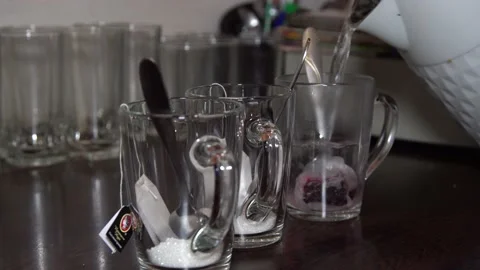 Close-up.  boiling water is poured from a kettle into a glass glass. Stock Footage 144395401