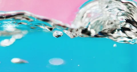 Close-up of Boiling Water in Slow Motion on a neon blue and pink background Stock Footage 124010932