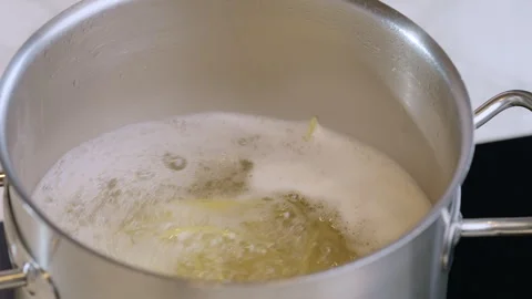 Close-up Boiling water with spaghetti in a pot. Slow motion video 100fps. Video stock 309294798