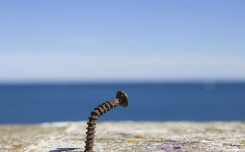A close-up of a bolt driven into a stone Stock Photos