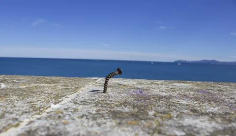 A close-up of a bolt driven into a stone Stock Photos