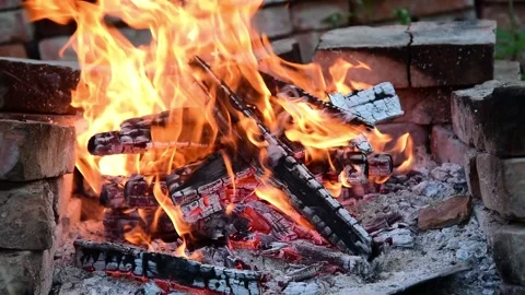 Close up bonfire flames of camping fire. brazier for a barbecue made of bricks. Video stock 138382240