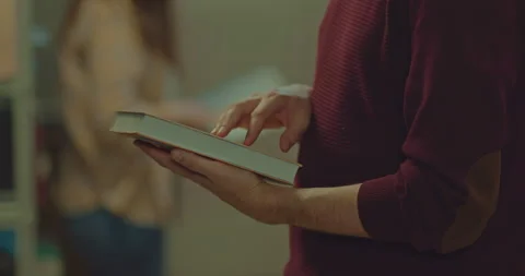 Close-up, a book in the hands of a man, a selection of interesting literature Stock Footage 177059347