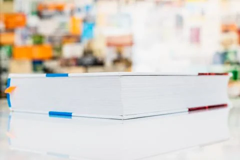 Close book lying on white table with soft background Stock Photos