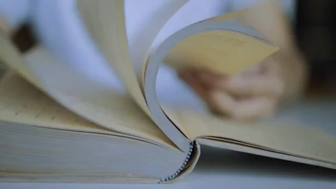 Close up of book pages flipping in slow motion Stockbeeldmateriaal 80521486