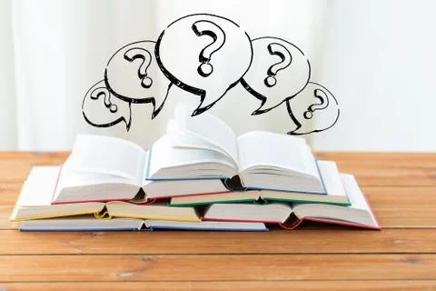 Close up of books on table and question marks Stock Photos
