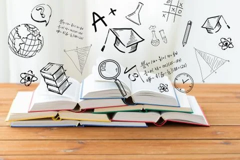 Close up of books on table over school doodles Stock Photos