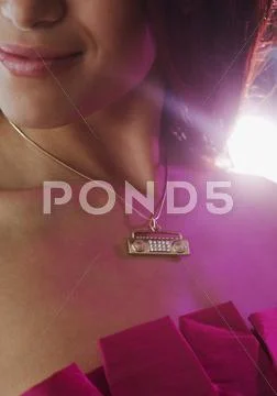 Close up of boom box necklace on hispanic woman Stock Photos