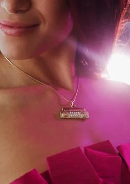 Close up of boom box necklace on hispanic woman Stock Photos
