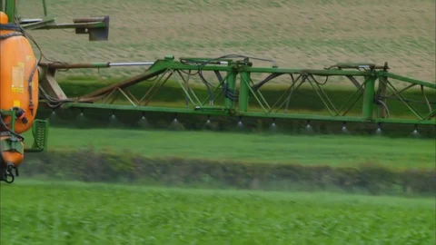 Close-up of Boom Sprayer Spraying Grass Field, UK Stock Footage 123880973