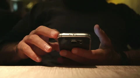 A close up of bored man chatting with his phone waitng food Stock-Footage 56089232