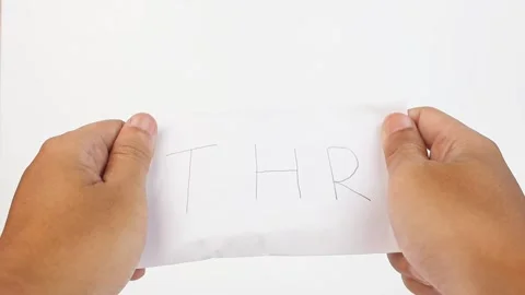 Close up of both hands holding an envelope with the words THR Stock Footage 328427609