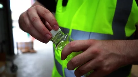 Close Up Of Bottle Lid Being Put Onto Bottle Stock Footage 155981848